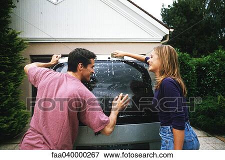 Couple washing car together View Large Photo Image Stock Photo - Couple washing car together. Fotosearch