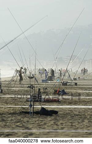Crowd of people with fishing poles on beach View Large Photo Image Stock Photo - Crowd of people with fishing poles on beach. Fotosearch