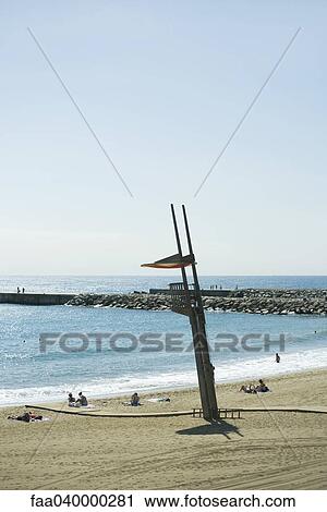 Empty lifeguard stand overlooking beach with sunbathers View Large Photo Image Stock Image - Empty lifeguard stand overlooking beach with sunbathers. Fotosearch