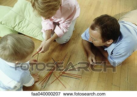 Family playing pick up sticks on floor View Large Photo Image Stock Photo - Family playing pick up sticks on floor. Fotosearch