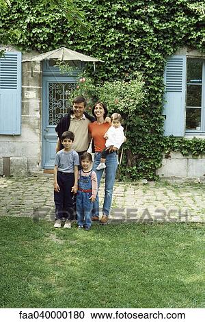 Family standing in front of house, portrait View Large Photo Image Stock Image - Family standing in front of house, portrait. Fotosearch