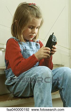 Girl dialing on portable phone View Large Photo Image Stock Image - Girl dialing on portable phone. Fotosearch