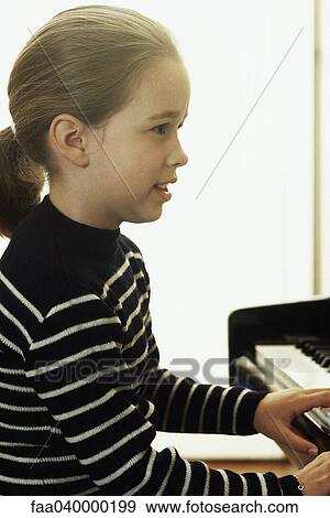 Girl playing piano View Large Photo Image Stock Photo - Girl playing piano. Fotosearch