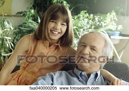 Grandfather and granddaughter smiling at camera, portrait View Large Photo Image Stock Photography - Grandfather and granddaughter smiling at camera, portrait. Fotosearch