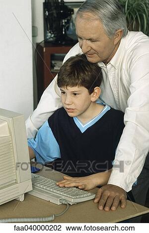 Grandfather and grandson using computer together View Large Photo Image Stock Image - Grandfather and grandson using computer together. Fotosearch