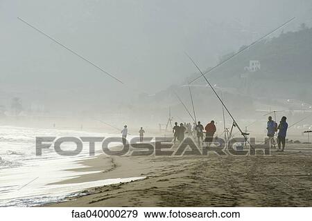 Group of people fishing on foggy beach View Large Photo Image Stock Photo - Group of people fishing on foggy beach. Fotosearch