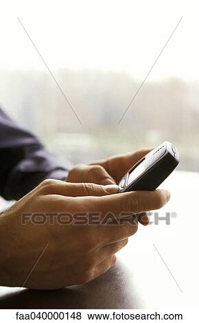 Hands holding cell phone, text messaging View Large Photo Image Stock Photo - Hands holding cell phone, text messaging. Fotosearch