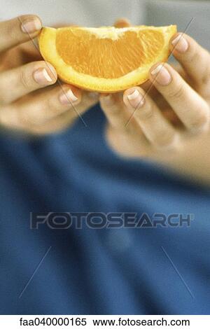 Hands holding orange slice View Large Photo Image Stock Photography - Hands holding orange slice. Fotosearch