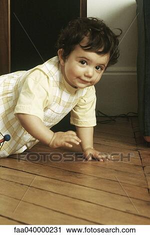 Little girl crawling on floor View Large Photo Image Stock Image - Little girl crawling on floor. Fotosearch