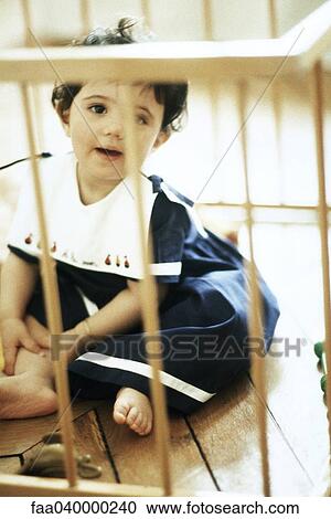 Little girl in playpen View Large Photo Image Stock Image - Little girl in playpen. Fotosearch