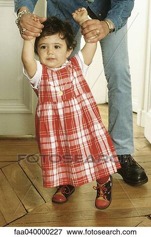 Mother helping daughter walk View Large Photo Image Stock Photo - Mother helping daughter walk. Fotosearch