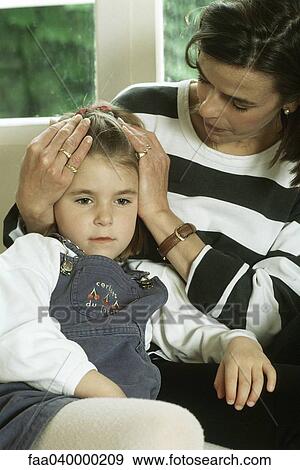 Mother holding daughter's head View Large Photo Image Stock Photo - Mother holding daughter's head. Fotosearch