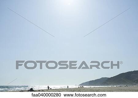 Sunny beach landscape, people in the distance View Large Photo Image Stock Image - Sunny beach landscape, people in the distance. Fotosearch