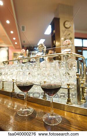Two glasses of wine side by side on counter View Large Photo Image Stock Photograph - Two glasses of wine side by side on counter. Fotosearch