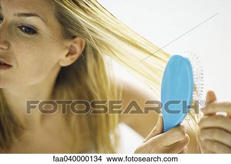 Woman brushing hair View Large Photo Image Picture - Woman brushing hair. Fotosearch