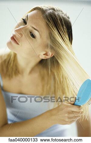 Woman brushing hair View Large Photo Image Stock Image - Woman brushing hair. Fotosearch