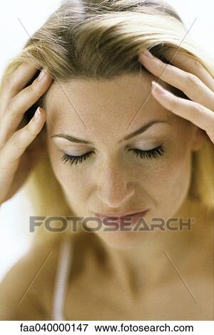 Woman holding head, eyes closed View Large Photo Image Stock Photo - Woman holding head, eyes closed. Fotosearch