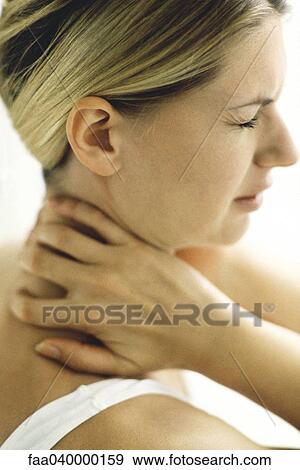 Woman holding neck, eyes closed View Large Photo Image Stock Photo - Woman holding neck, eyes closed. Fotosearch