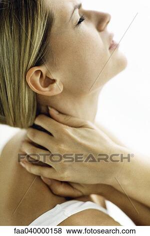 Woman holding neck with both hands, head back View Large Photo Image Stock Photo - Woman holding neck with both hands, head back. Fotosearch
