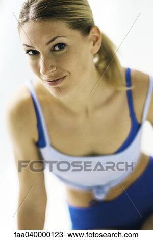 Woman in sports clothing, smiling at camera View Large Photo Image Stock Image - Woman in sports clothing, smiling at camera. Fotosearch