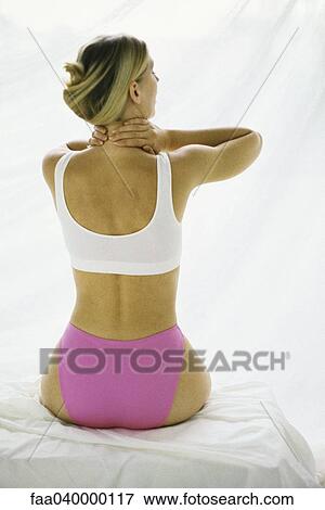 Woman in underwear, holding neck View Large Photo Image Stock Photo - Woman in underwear, holding neck. Fotosearch