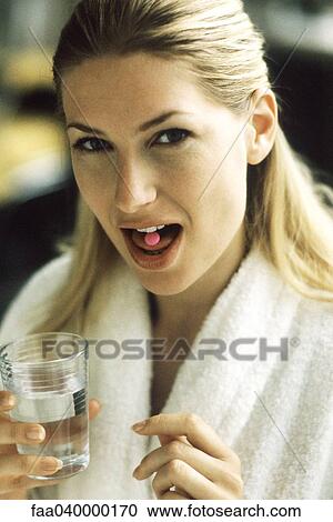 Woman opening mouth to show tablet on tongue View Large Photo Image Stock Image - Woman opening mouth to show tablet on tongue. Fotosearch