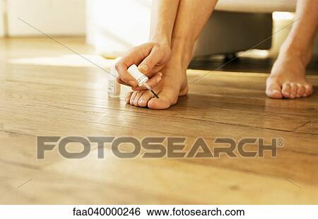 Woman painting toenails, cropped view View Large Photo Image Stock Photograph - Woman painting toenails, cropped view. Fotosearch