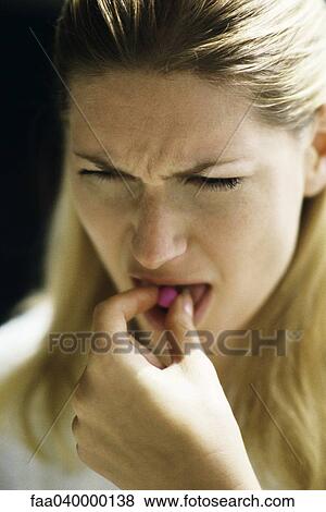 Woman placing pill on tongue View Large Photo Image Stock Photo - Woman placing pill on tongue. Fotosearch