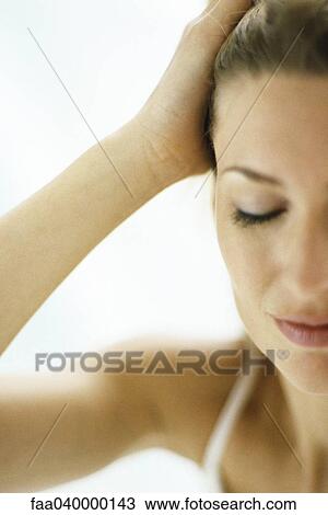 Woman pulling hair back, eyes closed View Large Photo Image Stock Image - Woman pulling hair back, eyes closed. Fotosearch