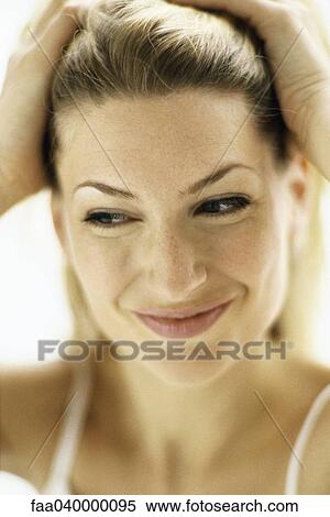 Woman pulling hair back, portrait View Large Photo Image Stock Photography - Woman pulling hair back, portrait. Fotosearch