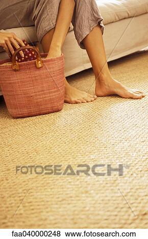 Woman reaching into bag on floor, low section View Large Photo Image Stock Photo - Woman reaching into bag on floor, low section. Fotosearch