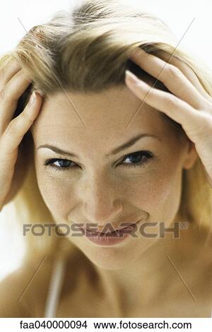 Woman running hands through hair, portrait View Large Photo Image Picture - Woman running hands through hair, portrait. Fotosearch