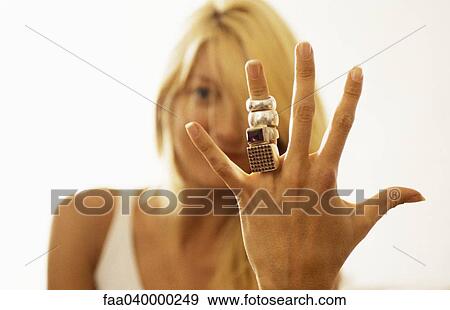 Woman showing many rings on her finger to camera View Large Photo Image Stock Photo - Woman showing many rings on her finger to camera. Fotosearch