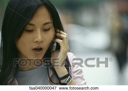 Woman talking on cell phone, close-up View Large Photo Image Stock Photo - Woman talking on cell phone, close-up. Fotosearch