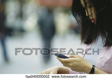 Woman text messaging with cell phone View Large Photo Image Stock Image - Woman text messaging with cell phone. Fotosearch