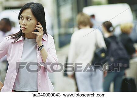 Woman using cell phone outdoors View Large Photo Image Stock Image - Woman using cell phone outdoors. Fotosearch