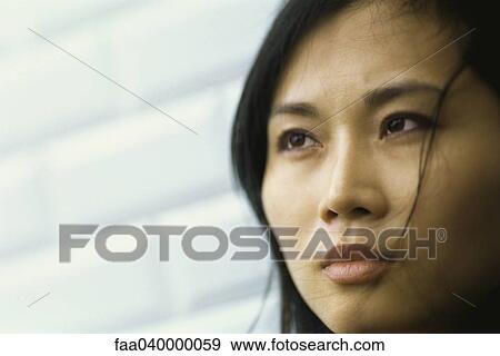Woman with hair blowing across face, portrait View Large Photo Image Stock Photo - Woman with hair blowing across face, portrait. Fotosearch