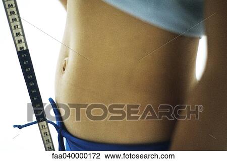 Woman's midriff and measuring tape View Large Photo Image Stock Image - Woman's midriff and measuring tape. Fotosearch