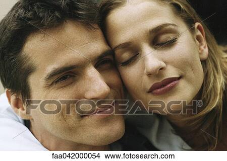 "Couple cheek to cheek, smiling, close-up" View Large Photo Image Picture - "Couple cheek to cheek, smiling, close-up". Fotosearch
