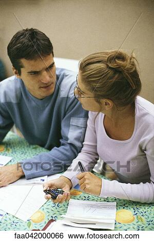 Couple discussing finances together View Large Photo Image Stock Photograph - Couple discussing finances together. Fotosearch