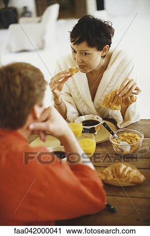 Couple eating breakfast at table View Large Photo Image Stock Image - Couple eating breakfast at table. Fotosearch