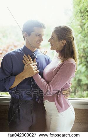 "Couple embracing, smiling at each other" View Large Photo Image Stock Photo - "Couple embracing, smiling at each other". Fotosearch