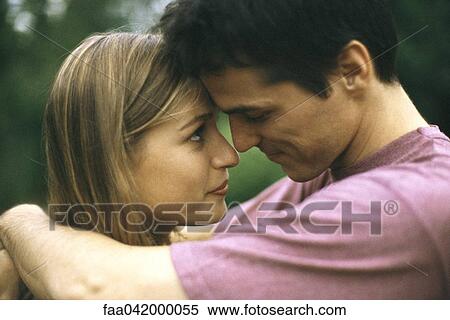 "Couple embracing, touching foreheads, side view" View Large Photo Image Stock Photography - "Couple embracing, touching foreheads, side view". Fotosearch