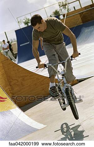Cylcist doing midair trick at skatepark View Large Photo Image Stock Photo - Cylcist doing midair trick at skatepark. Fotosearch