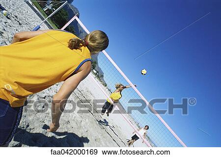Friends playing beach volleyball View Large Photo Image Stock Photo - Friends playing beach volleyball. Fotosearch