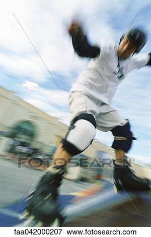 Inline skater sliding on ramp at skatepark View Large Photo Image Stock Photo - Inline skater sliding on ramp at skatepark. Fotosearch
