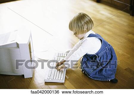 Stock Photograph - Little girl using computer. Fotosearch