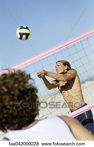 "Male playing beach volleball, preparing to hit ball" View Large Photo Image Stock Photo - "Male playing beach volleball, preparing to hit ball". Fotosearch