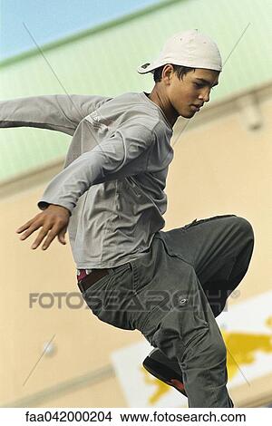 Picture - Male with arms out in midair. Fotosearch