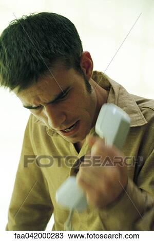"Man gripping phone receiver, furrowing brow" View Large Photo Image Stock Image - "Man gripping phone receiver, furrowing brow". Fotosearch